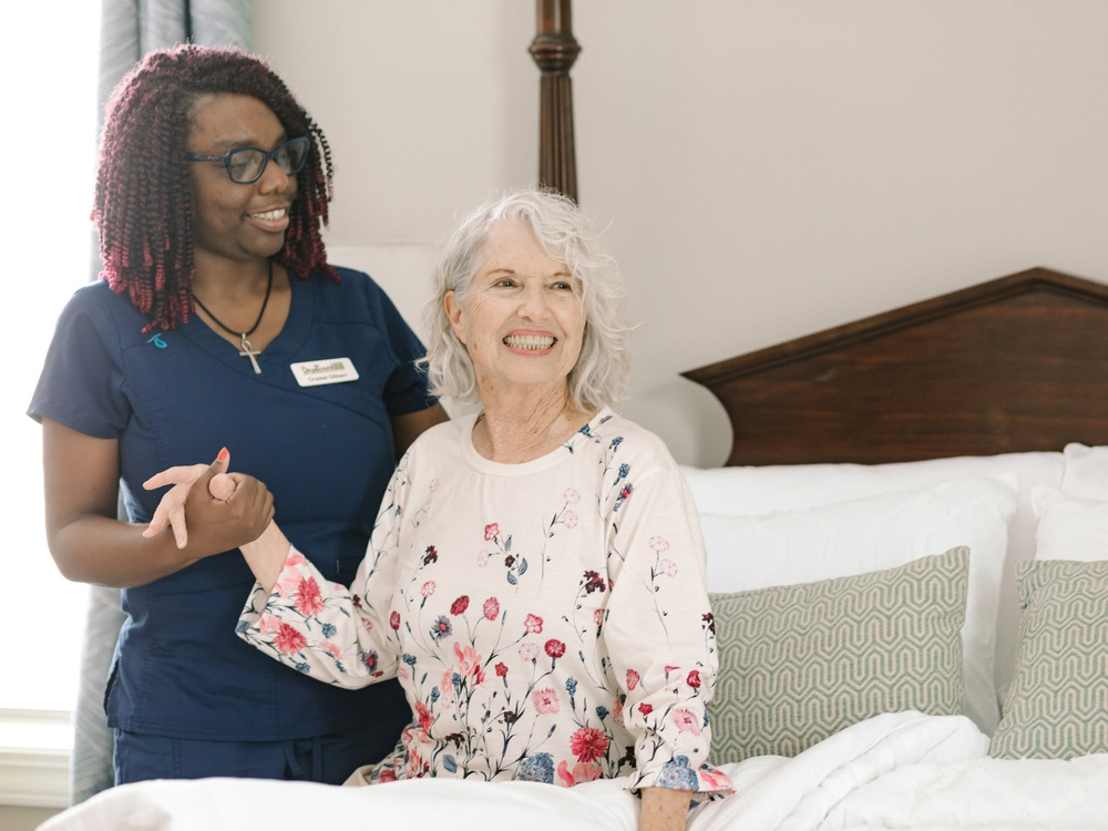 DayBreak caregiver helping an older adult client at home