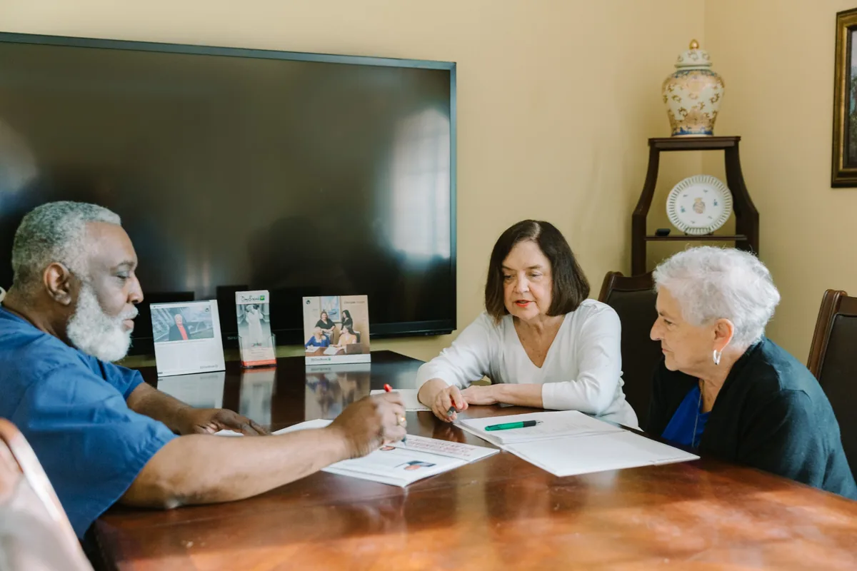 DayBreak team meeting with an older adult and family members around a table
